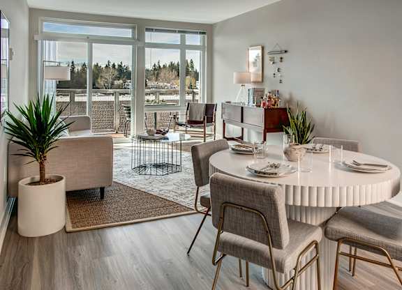 A dining room with a round table and chairs.