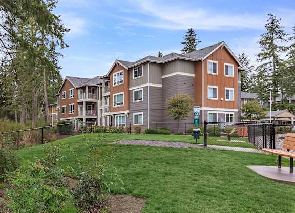 A large apartment complex with a grassy area in front.