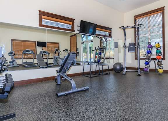 A spacious home gym with a variety of exercise equipment.