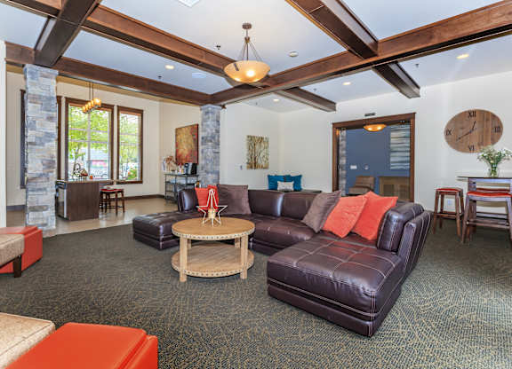 A living room with a large couch and a stone pillar.