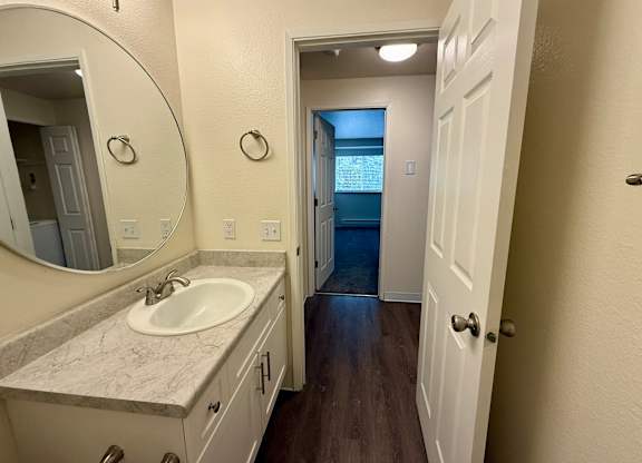 A bathroom with a sink and mirror.