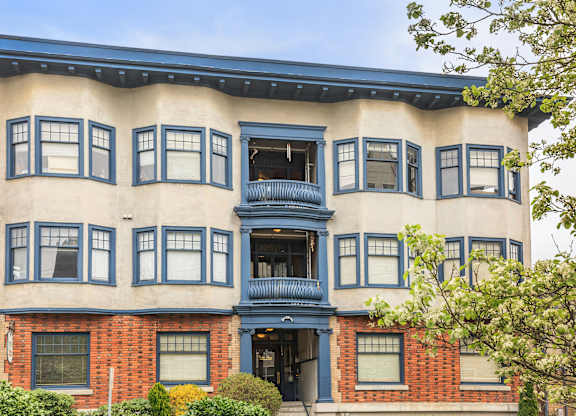 A building with a blue awning and a balcony.