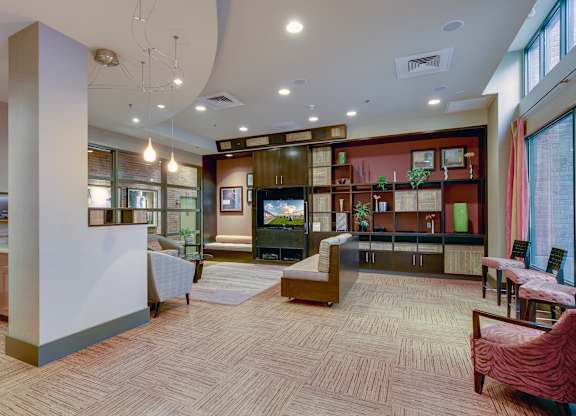 A spacious room with a wooden floor and a variety of furniture and decorations.