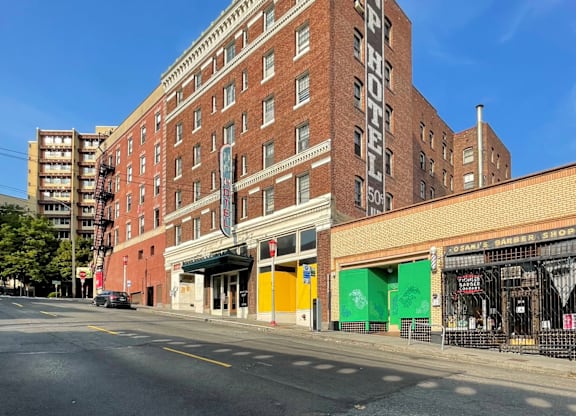 A large red brick building with the words "NY PYTHON HOTEL" on the side.