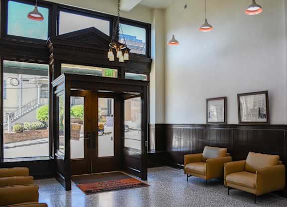 A room with a brown chair and a brown door.