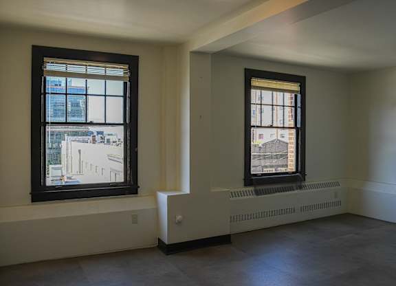 A room with a window and a radiator on the wall.