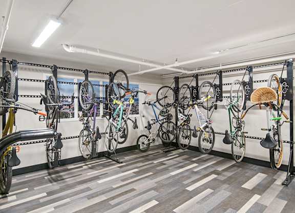 A bike shop with many bikes hanging on the wall.