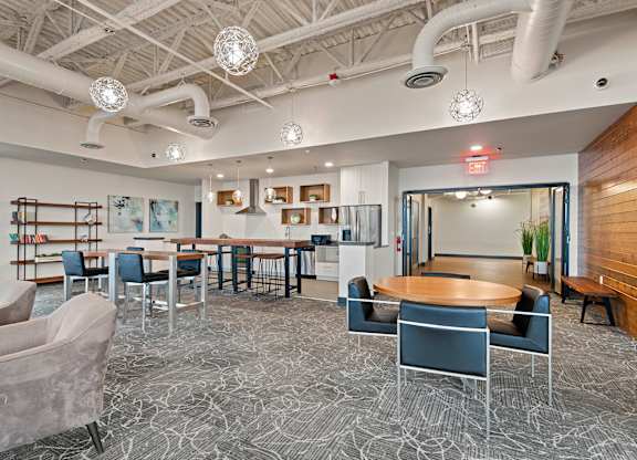 A modern office space with a patterned carpet and a variety of seating options.