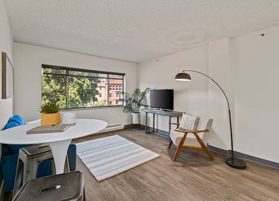 A living room with a white table and a television.