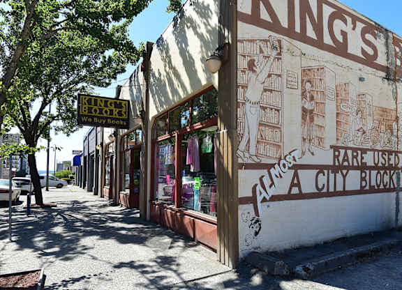 A book store named King's Books is located on a sidewalk.