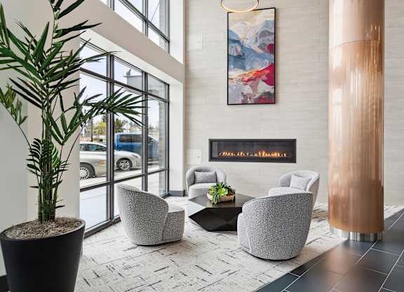 A modern waiting area with a large painting on the wall and comfortable seating.
