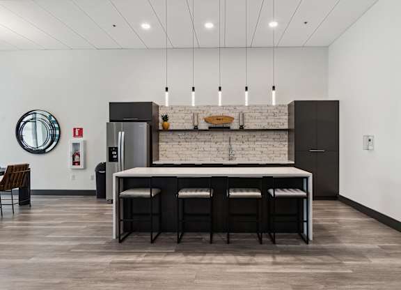 A kitchen with a white brick wall and a marble countertop.