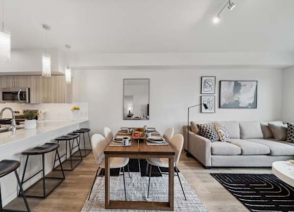 A modern kitchen with a dining table and chairs.