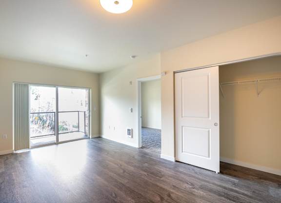 A large empty room with a sliding glass door.
