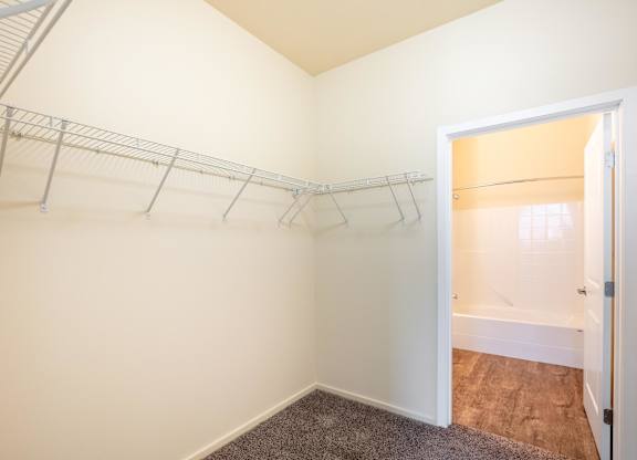 A white wall with a metal rack on it.
