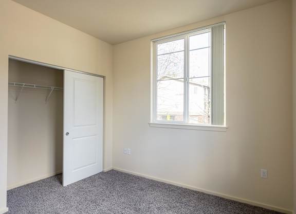 A room with a white door and a window.