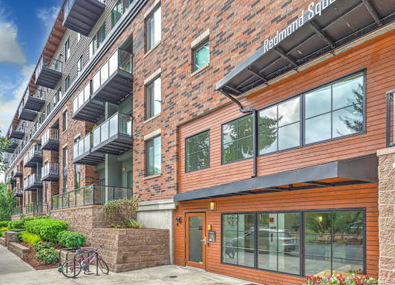 A red brick building with a balcony on the second floor.