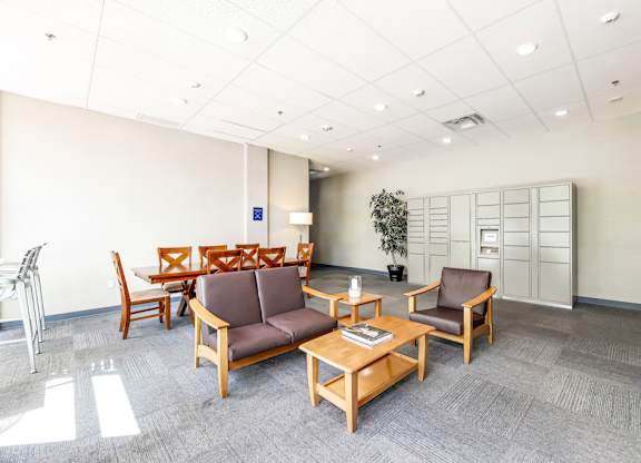A waiting room with brown chairs and a wooden table.