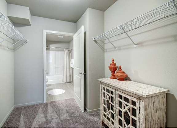 A hallway with a wooden cabinet and a carved object on top of it.