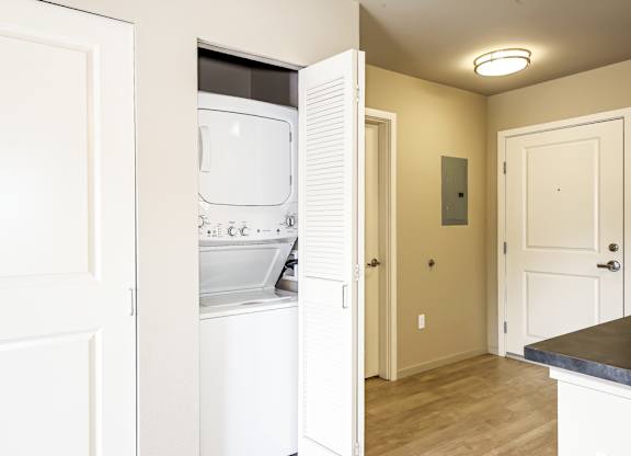 A white oven and microwave are installed in a kitchen.