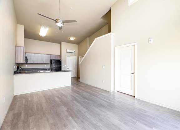 A spacious kitchen with a fan on the ceiling.