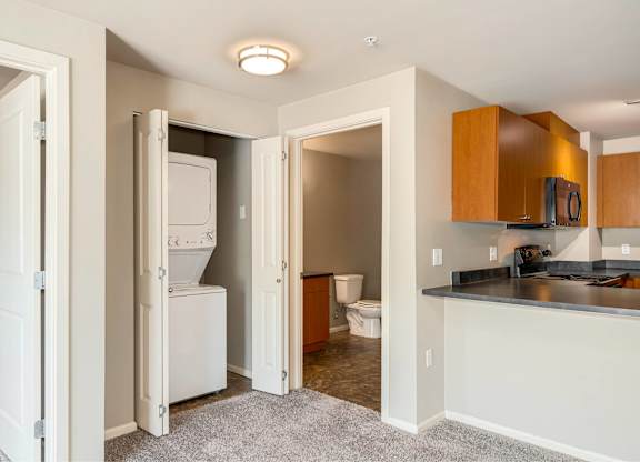 A kitchen area with a refrigerator, microwave, and toaster visible.