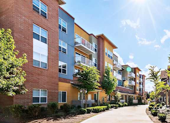 A sunny day at a residential building with a clear blue sky.