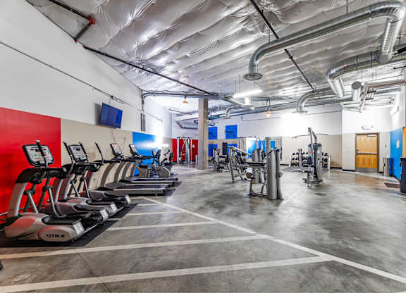 A gym with treadmills and other exercise equipment.