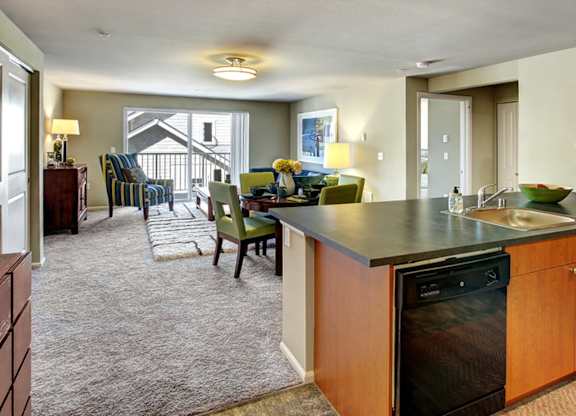 A kitchen with a black dishwasher and a sink.