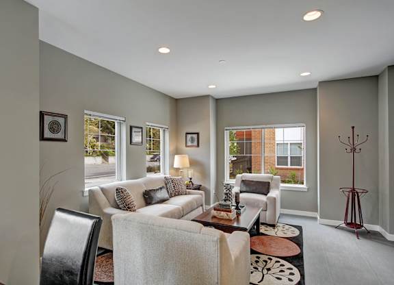 A living room with a couch, chairs, and a coffee table.