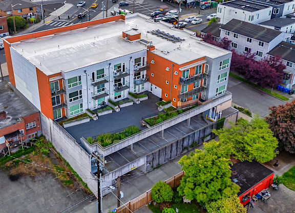 A modern apartment building with orange and white exterior.