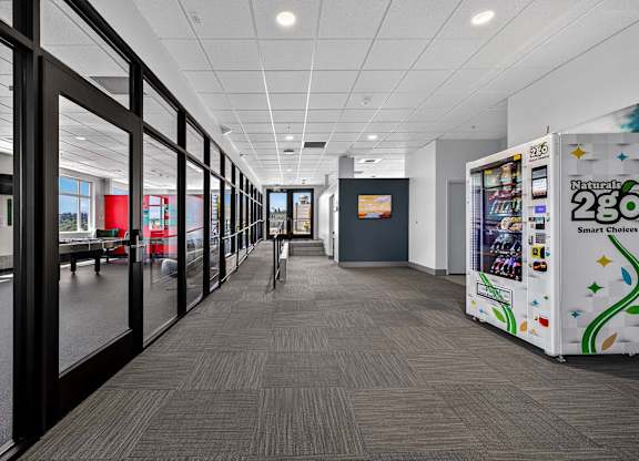 A long hallway with a vending machine on the right.