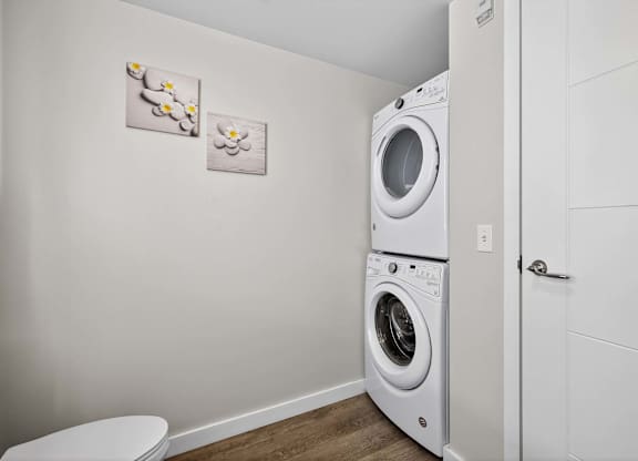 A white washing machine and dryer in a small laundry room.