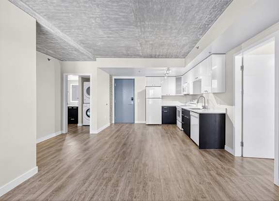 A kitchen with a washer and dryer built in.