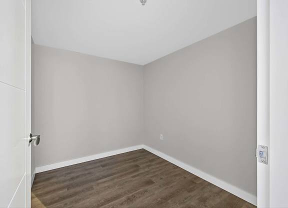 A room with a wooden floor and white walls.