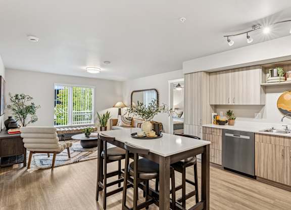 A modern kitchen with a dining table and chairs.