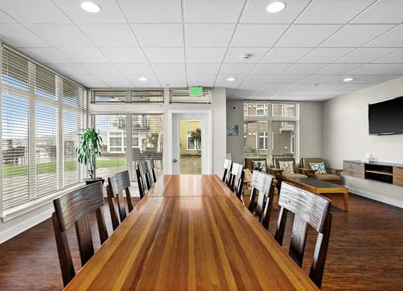 A conference room with a long table and chairs.