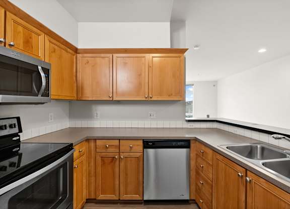 A kitchen with wooden cabinets and stainless steel appliances.