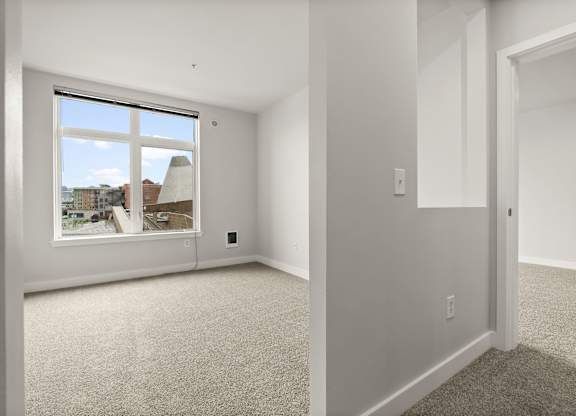 A room with a window overlooking a cityscape.