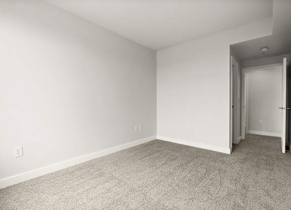 A room with a carpeted floor and white walls.
