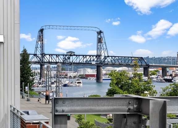A bridge over a body of water with boats underneath.