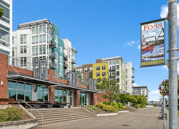 A building with a sign that says "FOSS" on a pole.
