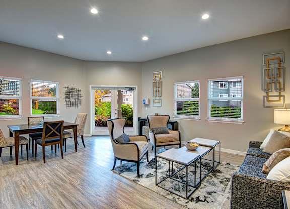 A living room with a couch, chairs, and a coffee table.