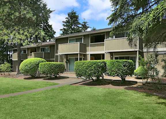 A building with a green lawn in front of it.