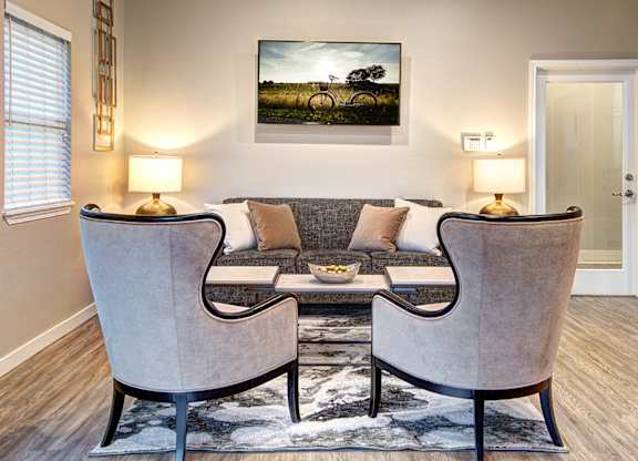A living room with two chairs and a couch.