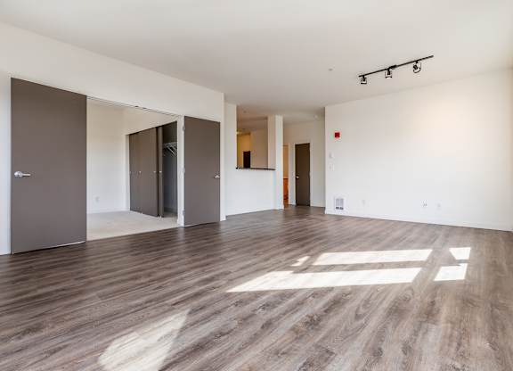 A room with wooden floors and white walls.