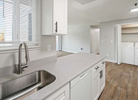A kitchen with a sink and cabinets.