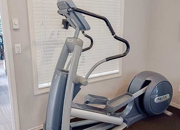 A Prado elliptical trainer is on the floor in a room.