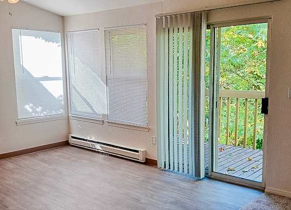 A room with a sliding glass door leading to a balcony.