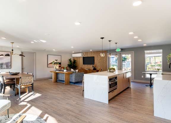 A modern kitchen with a dining table and chairs.